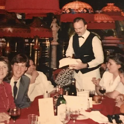 Waiter serves food to patrons